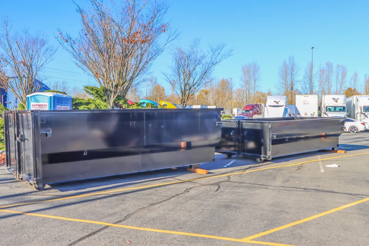 Professional dumpster rental service with roll-off container on residential driveway in Bell
